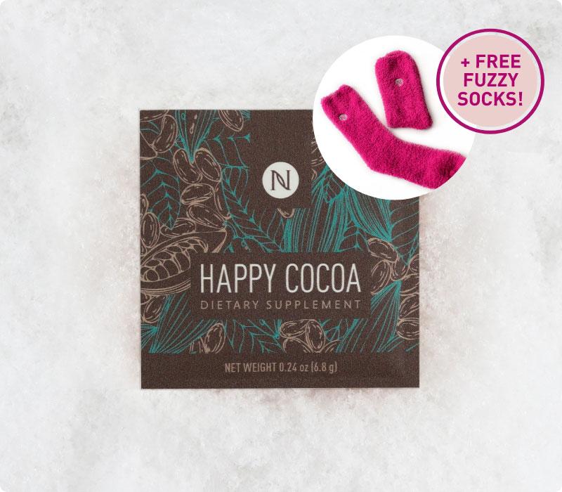 Neora’s hottest holiday limited-time must-have, Happy Cocoa, laying on a bed of snow with a callout about getting FREE Fuzzy Socks with every order!
